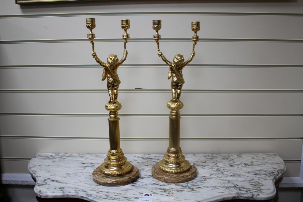 A pair of Italian gilt metal candelabra, with putto stems and marble bases, height 51cm